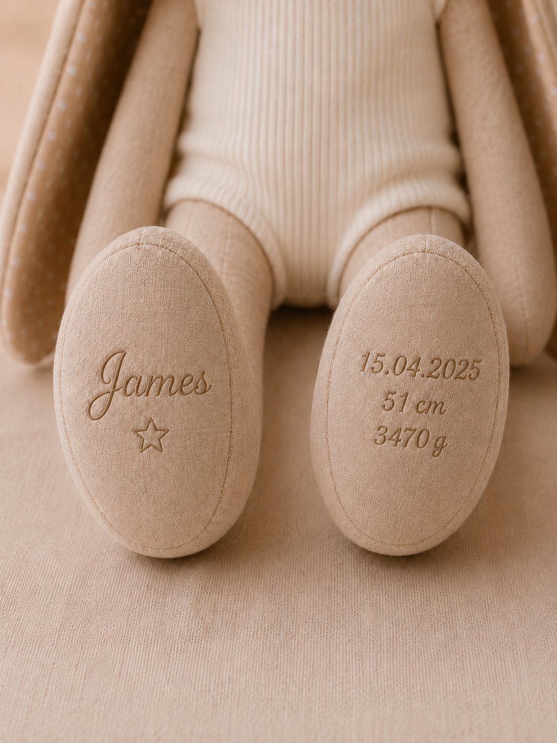 Close-up of James bunny's feet, name and birth details embroidered